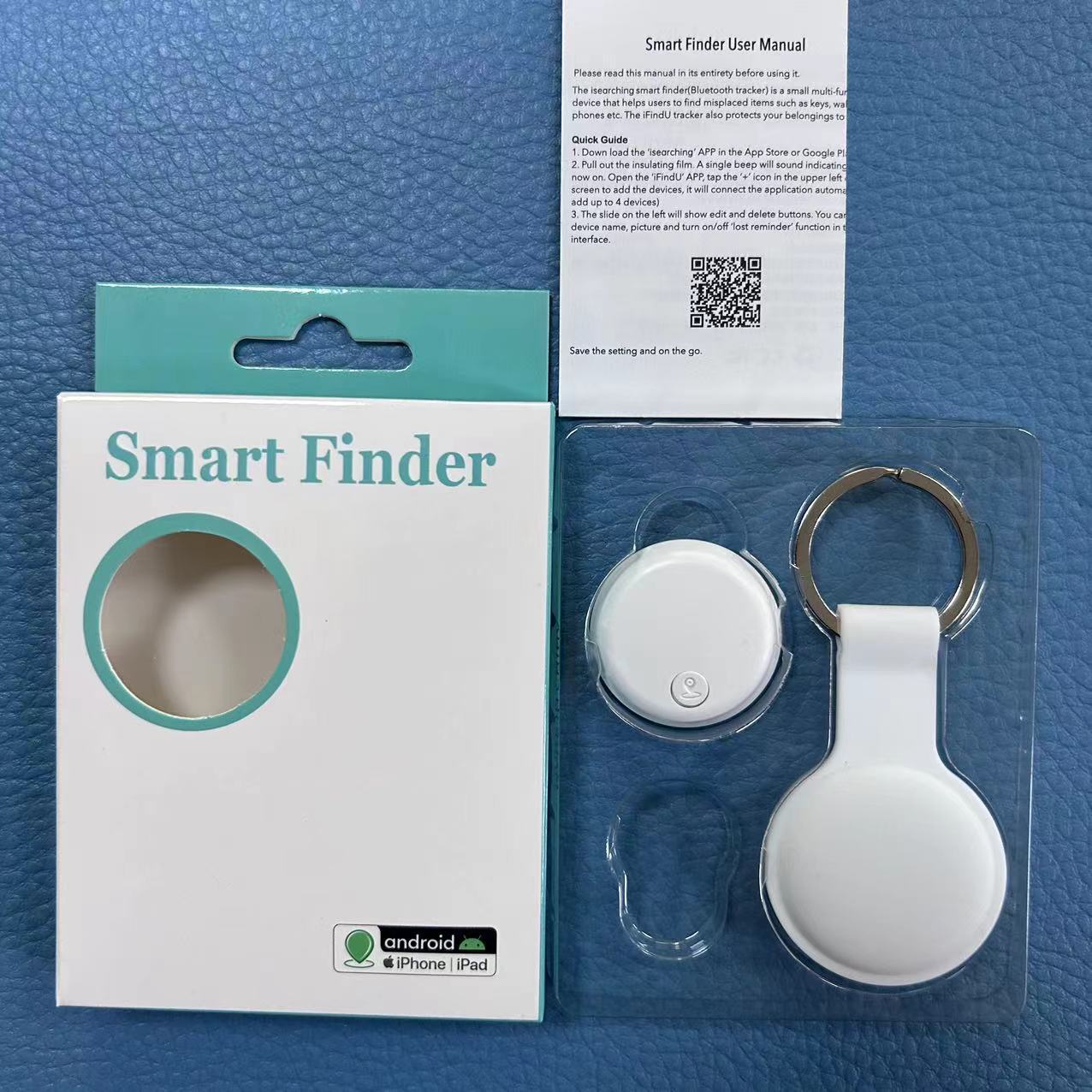 Smart anti-loss Bluetooth tracking device in white with packaging, keychain, and user manual on a blue textured background