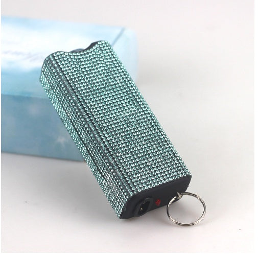 Teal glittery flashlight with a keyring on a light background