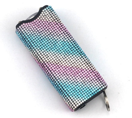 Multicolored rhinestone flashlight on a white background