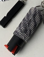 Keychain with metallic design and red accent on a black background