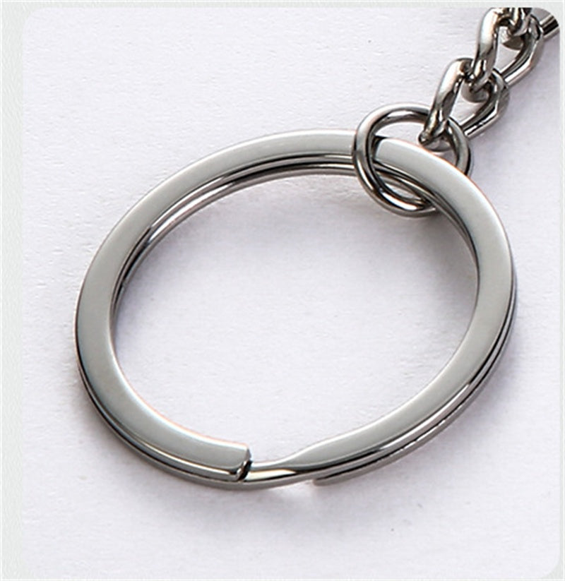 A keychain with a split shackle design and a matching metal key chain link, shown on a plain white background.
