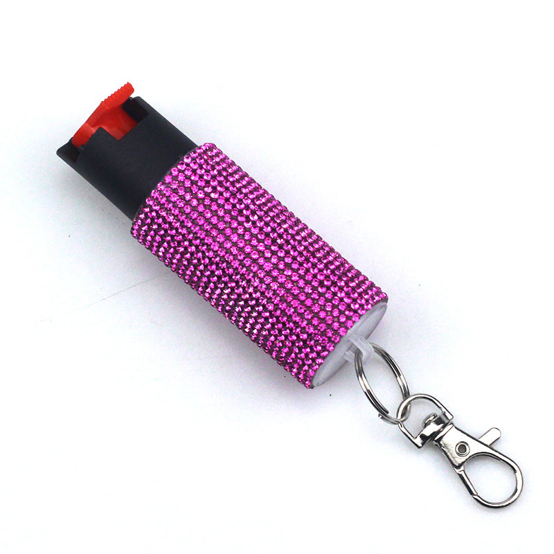Pink pepper spray with keychain on a white background