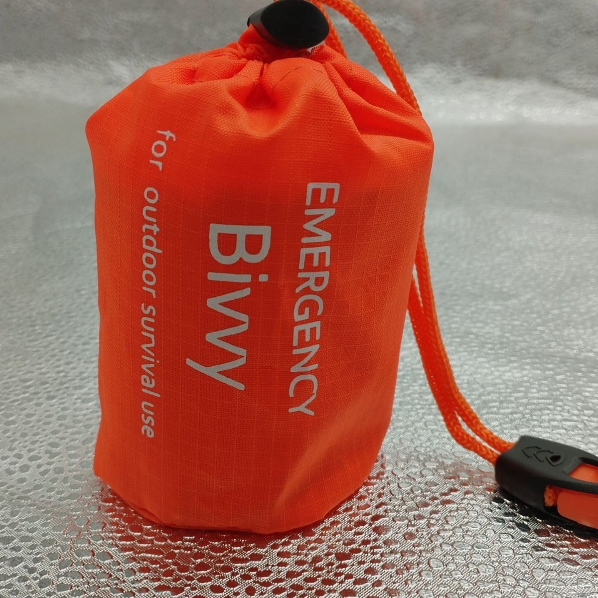Heat-reflective emergency sleeping bag for cold weather survival