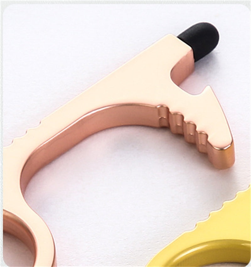 A close-up of a rose gold metal tension wrench with a black rubber tip, shown on a white background with a yellow version partially visible in the corner.
