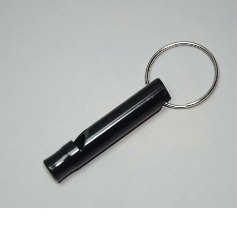 Black safety keychain whistle on a gray background
