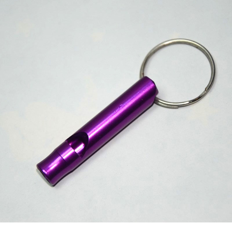 Purple metal keychain rescue whistle on a white background