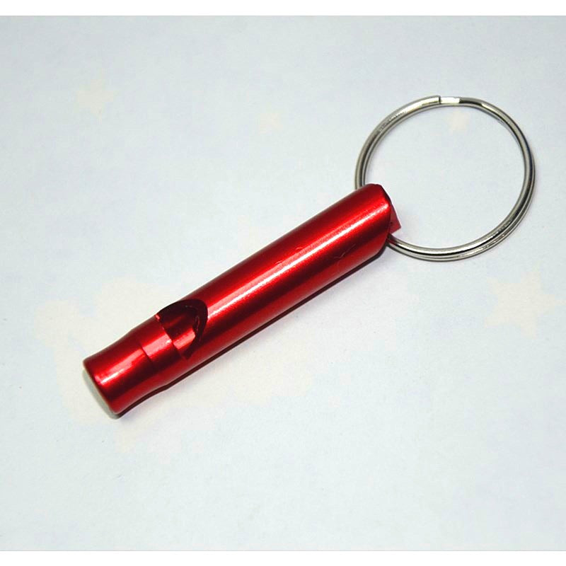 Red metal rescue whistle keychain on a light gray background