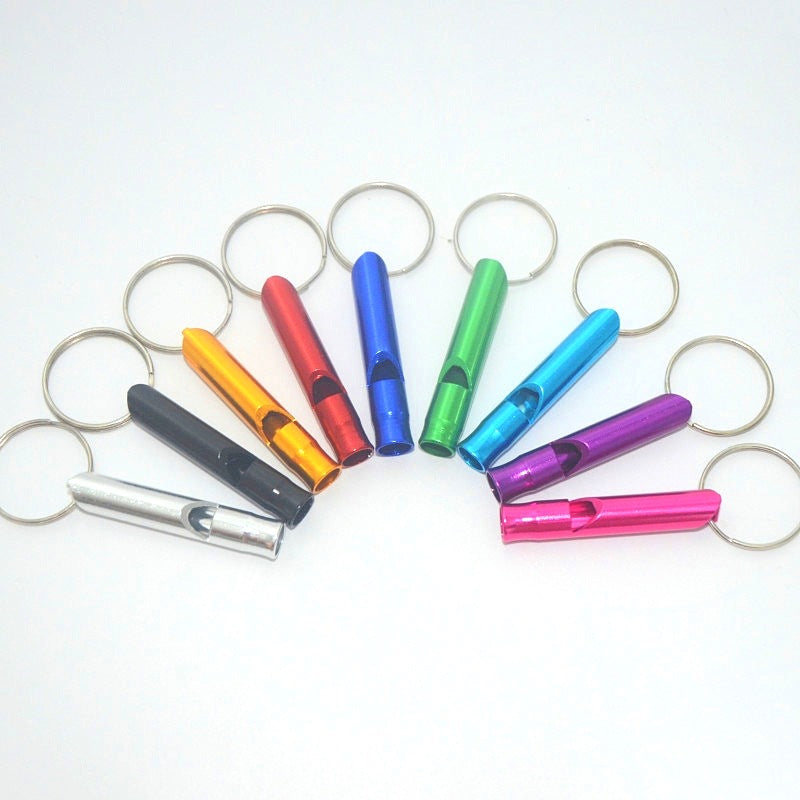 Colorful safety keychain whistles on a white background