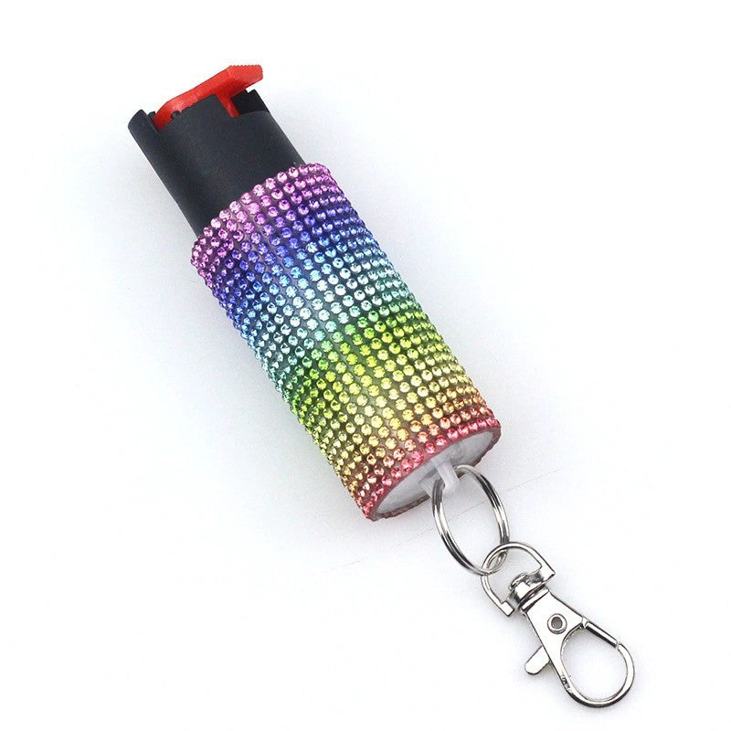 Rainbow-colored pepper spray with a keychain on a white background