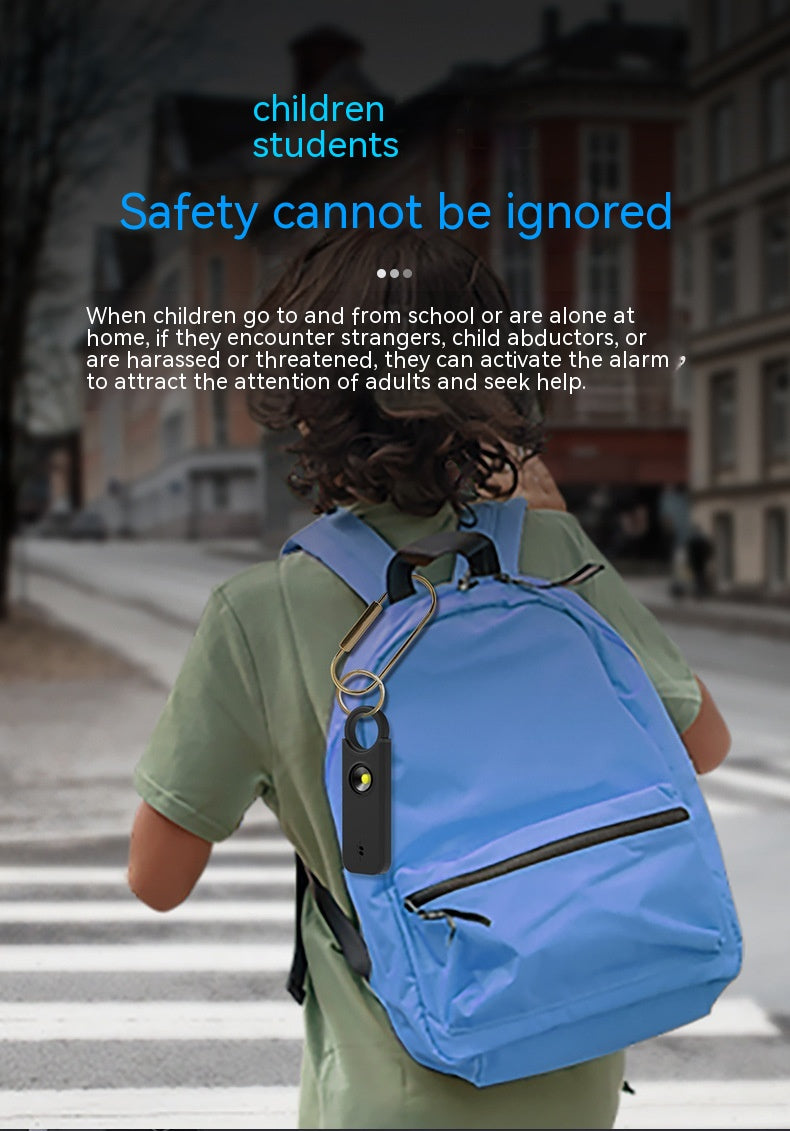Person wearing a blue backpack with safety alarm keychain