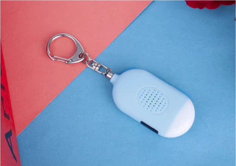 Blue keychain device with a white tag on a red and blue background