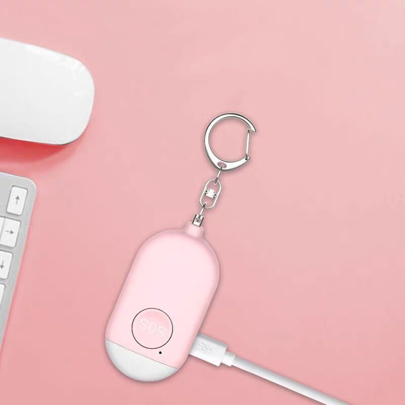 Pink USB device with keychain on a pink background