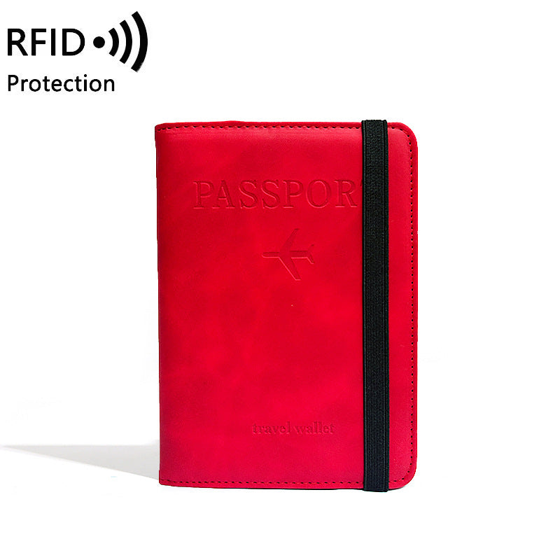 Red passport holder with black strap on a white background, featuring RFID protection text.