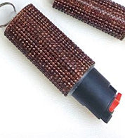 Brown textured keychain with a red and gray component on a white background