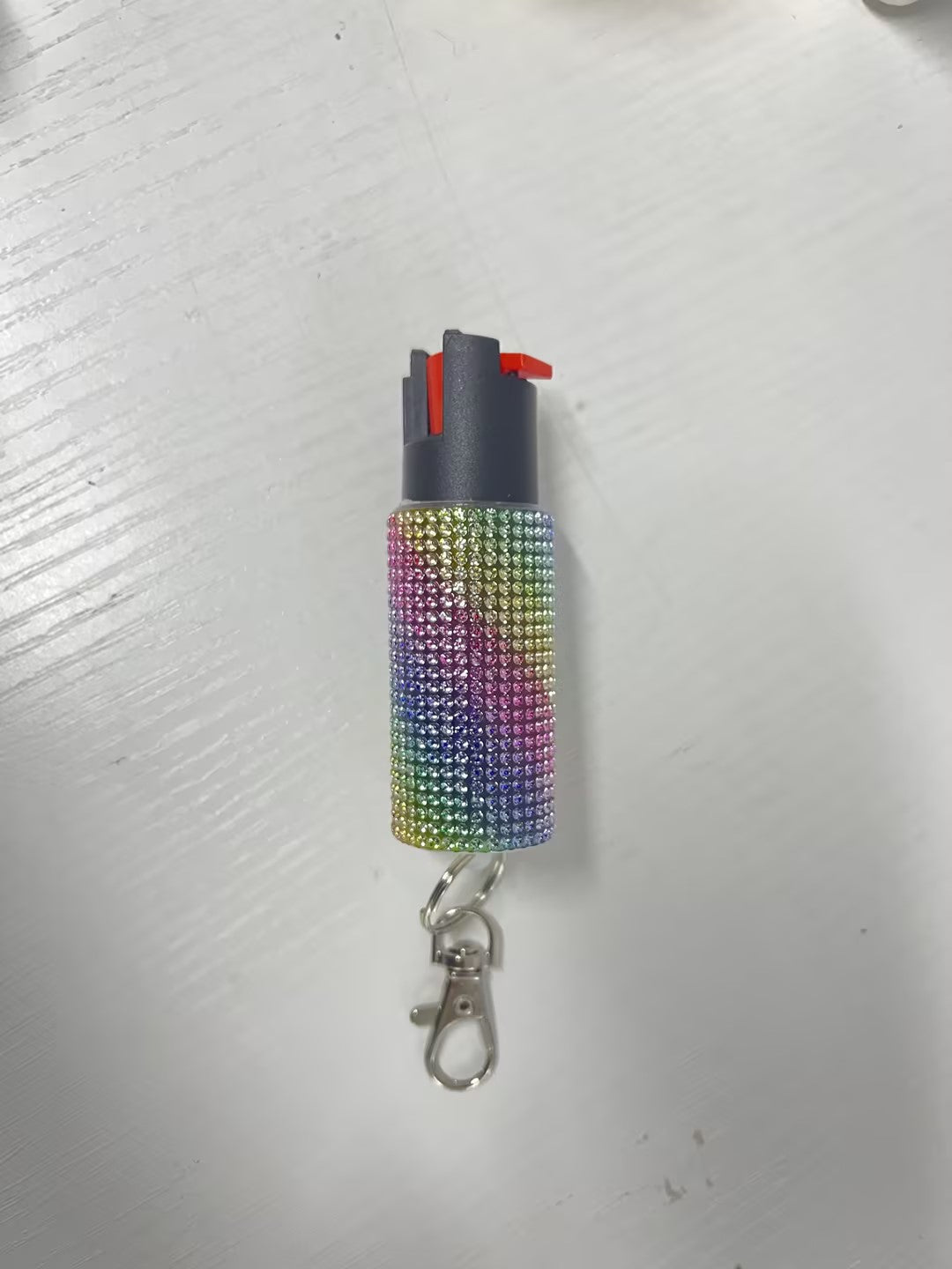Multicolored rhinestone lighter on a white background