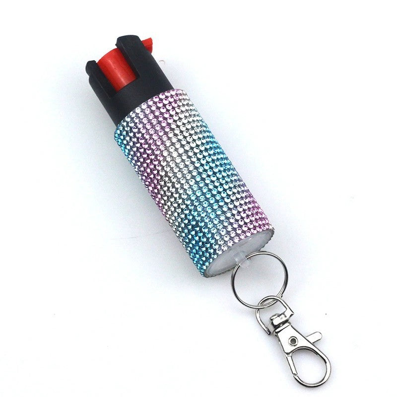 Blurred image of a pepper spray with a keychain on a white background