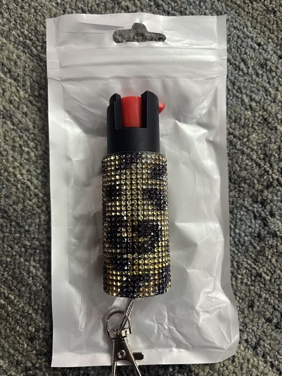 Blurred pepper spray with decorative cover on a white background