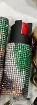 Two pepper spray with different designs on a textured surface