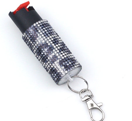 Pepper spray with bling keychain on a white backgrounds