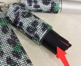 Close-up of a pepper spray with a red arrow pointing to a specific section