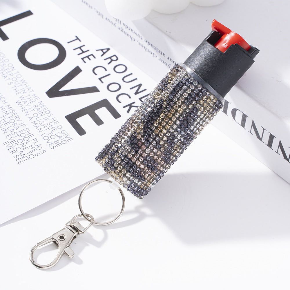 pepper spray with rhinestone embellishments on a magazine page