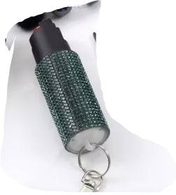 Decorative keychain with green gemstones on a white background