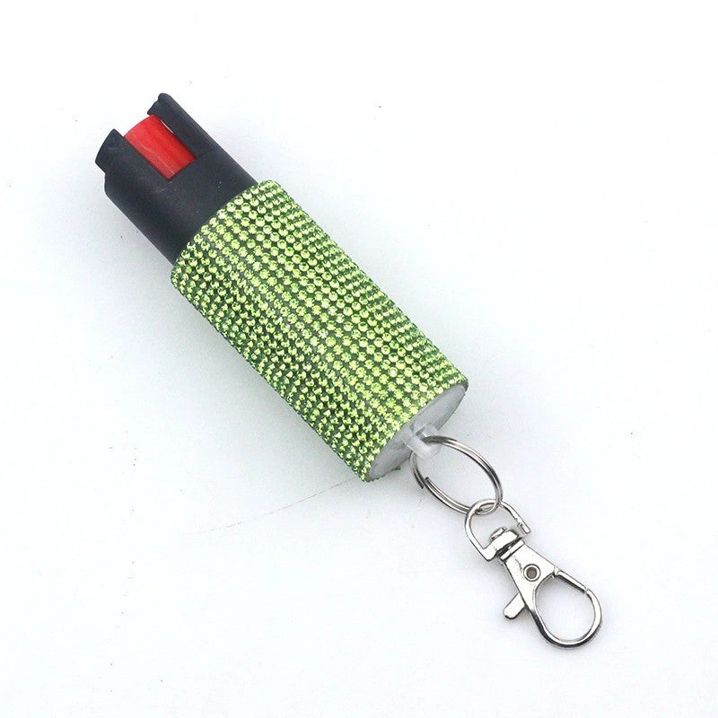 Green pepper spray with keychain on a white background