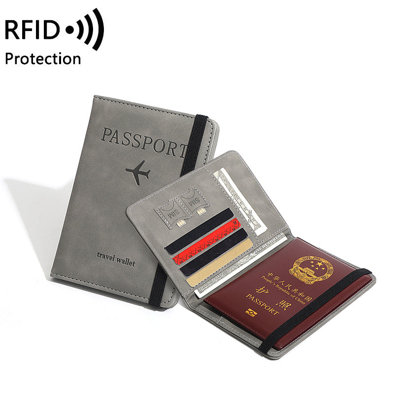 Gray travel wallet with passport holder and card slots on a white background, featuring RFID protection.