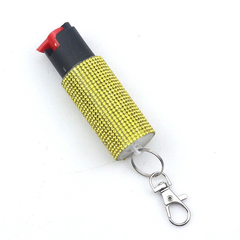 Pepper spray Keychain with a yellow rhinestone-studded container on a white background